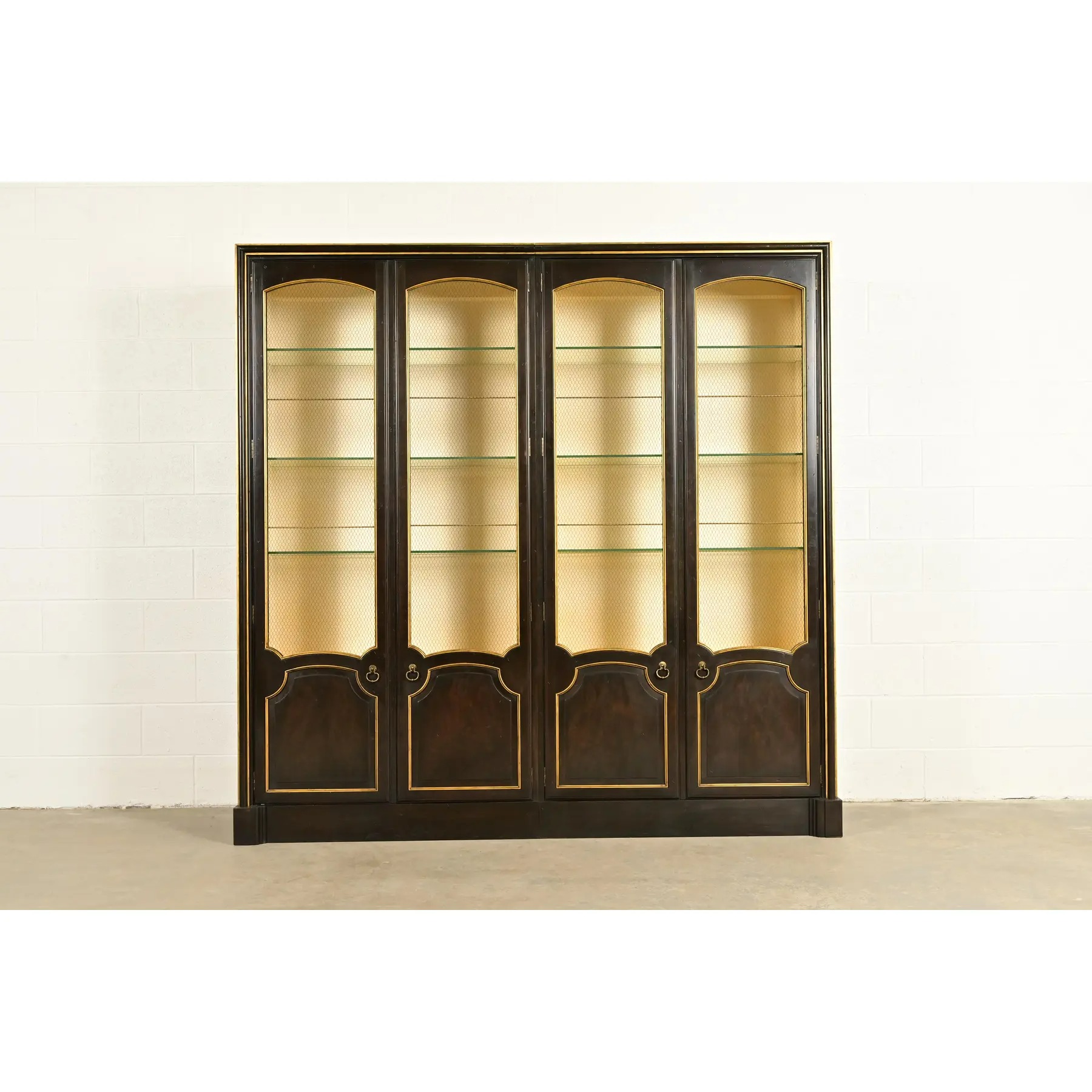 Baker Furniture French Regency Louis XVI Carved Walnut and Parcel Gilt Lighted Breakfront Bookcase Cabinet, Circa 1960s