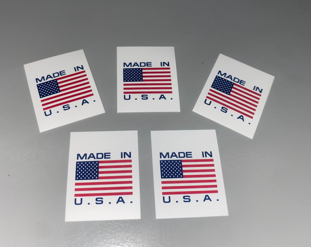 Made in USA flag labels featuring the American flag, printed and processed domestically by American Law Label