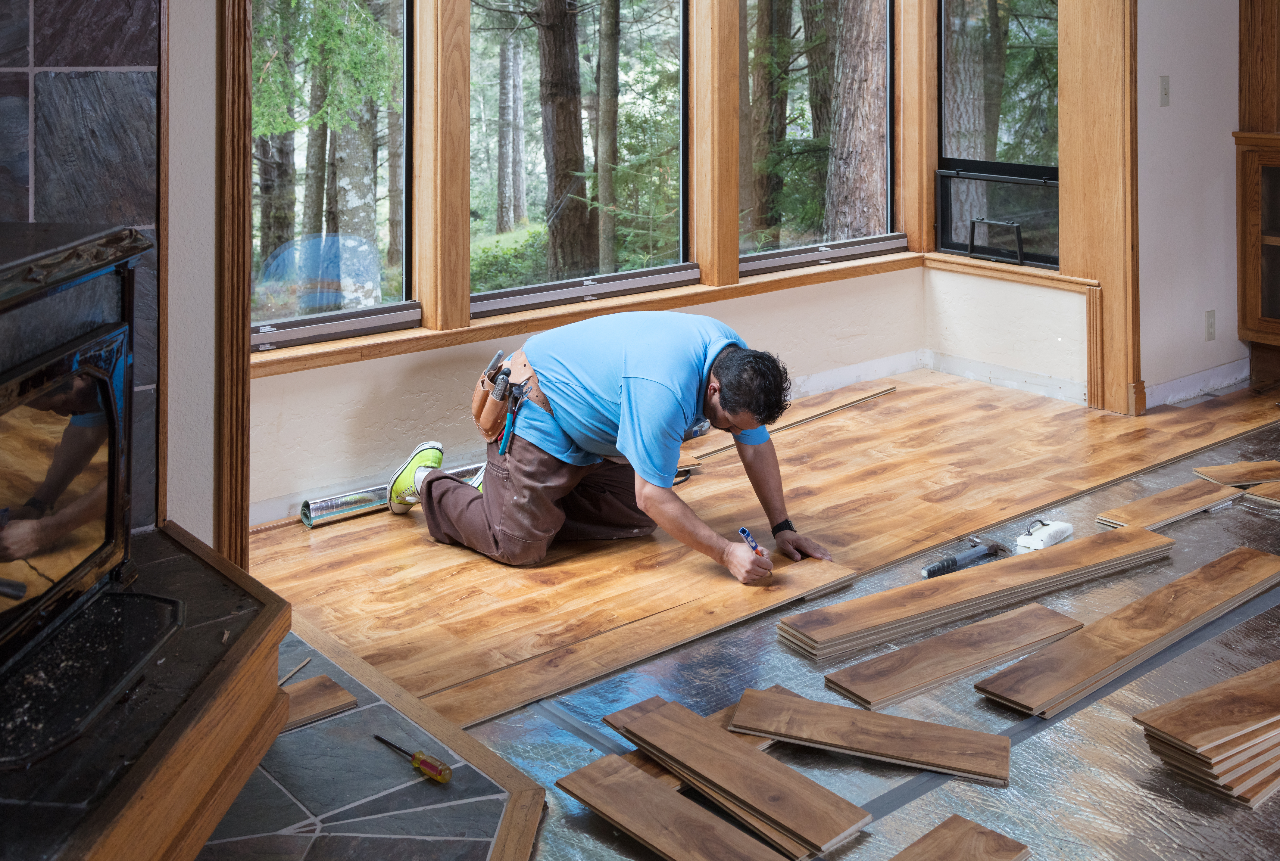man installing floor in kitchen