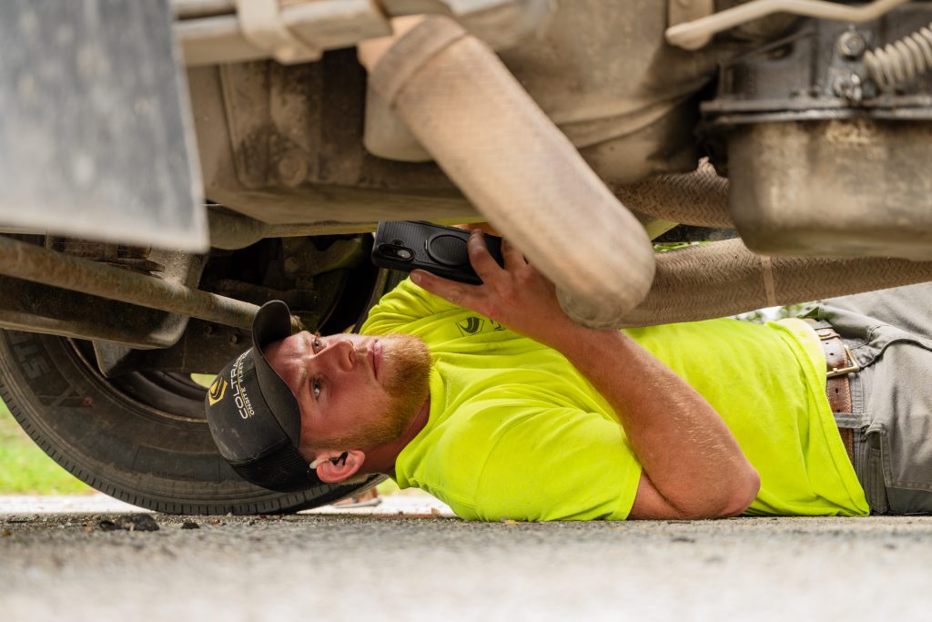 Coltrain Onsite Fleet Care technician uses SHIELD™ to conduct an electronic preventive maintenance inspection underneath a fleet vehicle.