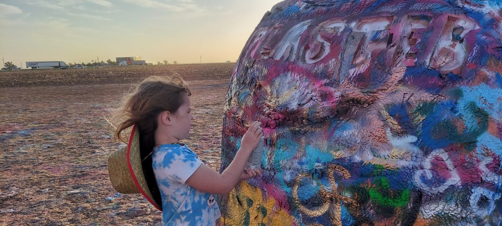 Ann K. Emery's daughter at Cadillac Ranch in Amarillo, TX.