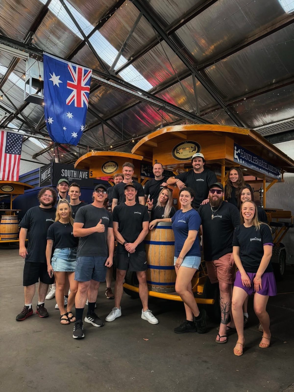 The HandleBar Adelaide crew standing together in front of the pedal bikes at the HomeBase warehouse