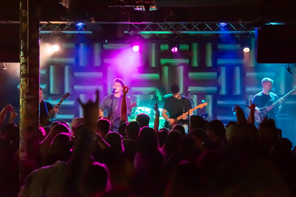 band performs on stage in front of a crowd