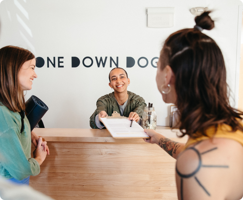 Students checking in for yoga class at One Down Dog's front desk in East Hollywood LA