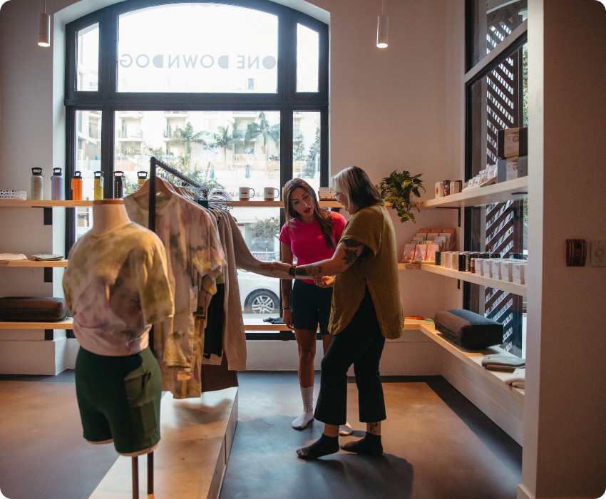 Two yoga students shopping for apparel in the retail section of One Down Dog East Hollywood LA