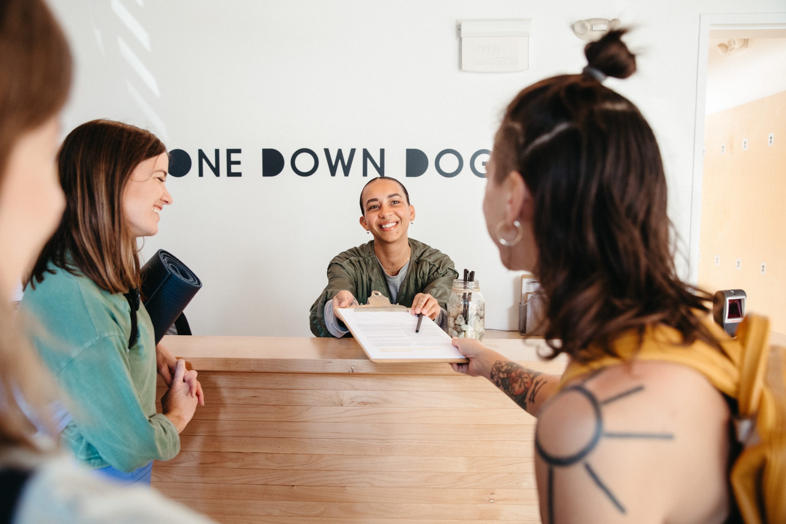 image of new students at the front desk of a yoga studio in Los Feliz